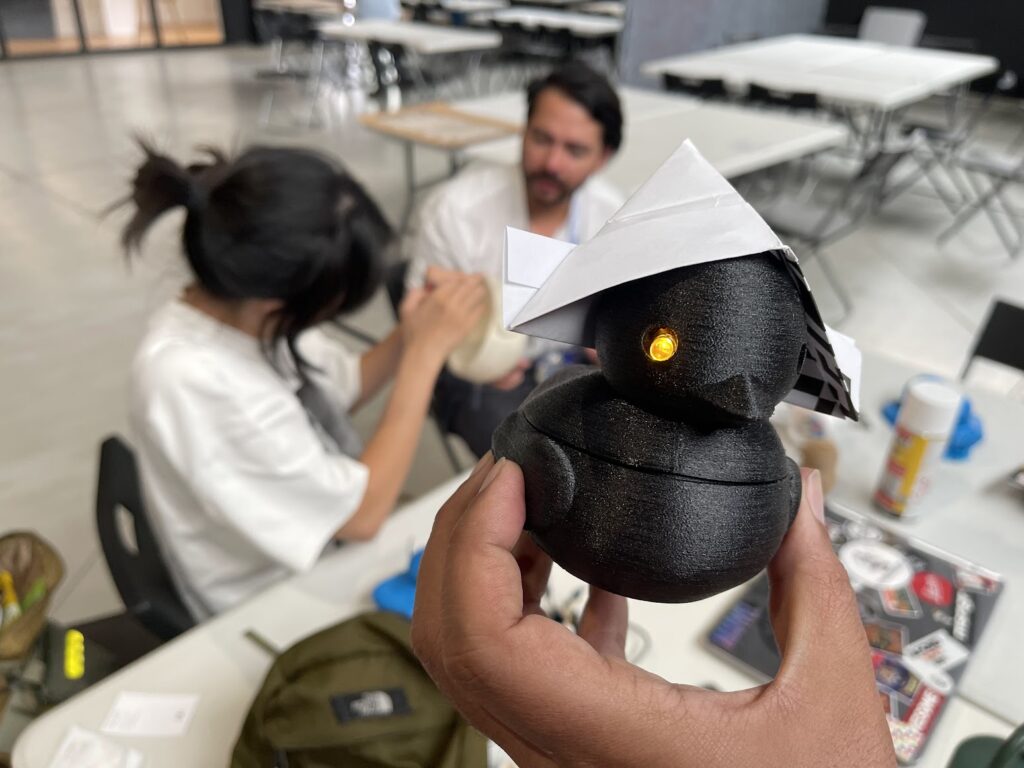 3d printed ducky with an origami paper hat because captain ducky